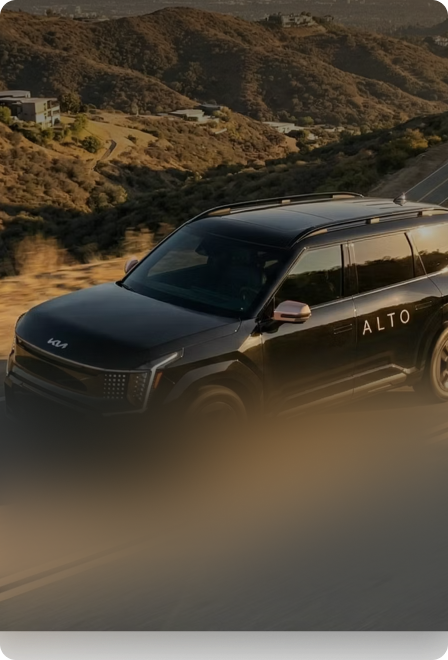 An Alto vehicle on a hillside road at golden hour